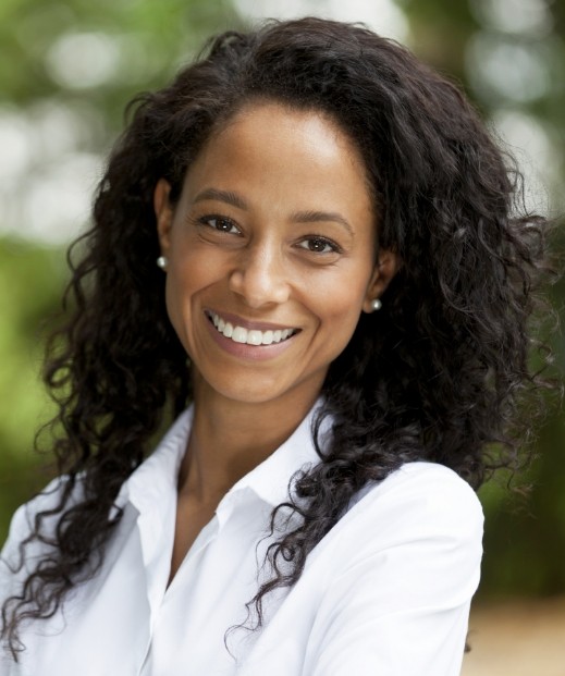 Woman smiling outdoors after sleep treatments in McKinney