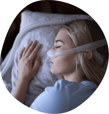 Woman sleeping while wearing C P A P mask