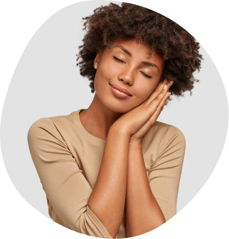 Woman closing her eyes and making a pillow for her head with her hands