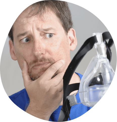 Man looking skeptically at C P A P mask