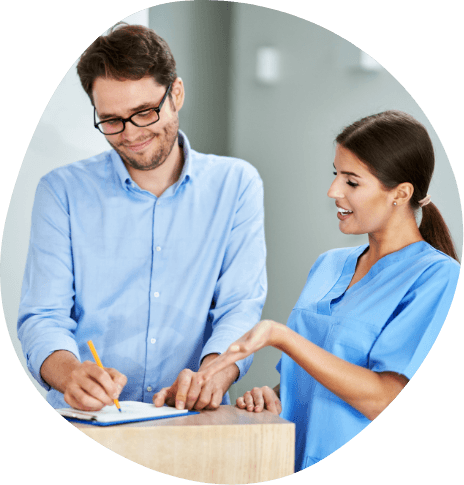 Sleep center team member showing man where to sign on clipboard