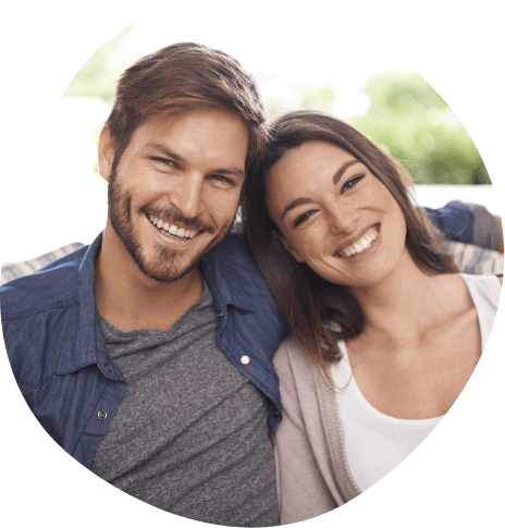 Young man and woman smiling outdoors