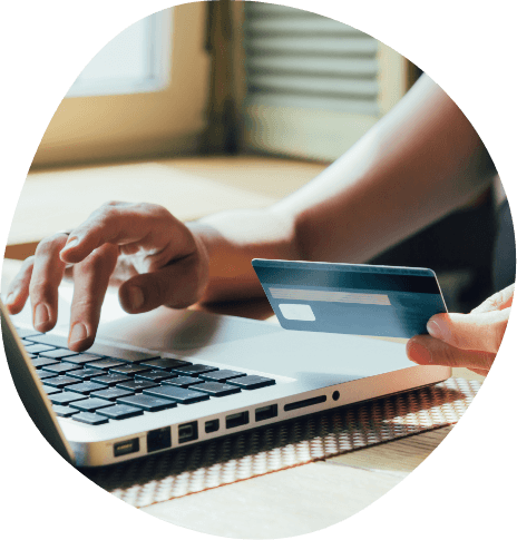 Person entering credit card information into laptop