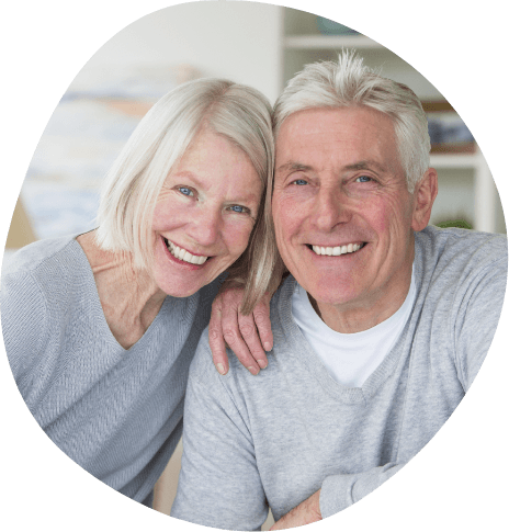 Smiling senior man and woman in gray cardigans