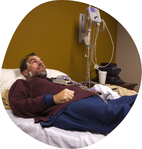 Man hooked up to electrodes for sleep apnea testing