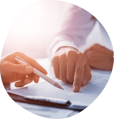 Person showing another person where to sign on paper