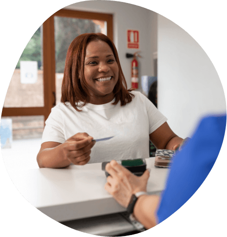 Woman talking to front desk team member at sleep center