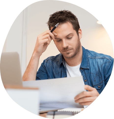 Tired man looking at paperwork