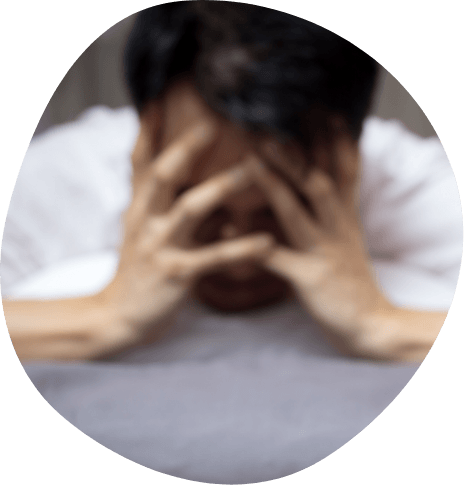 Man in bed with his head in his hands