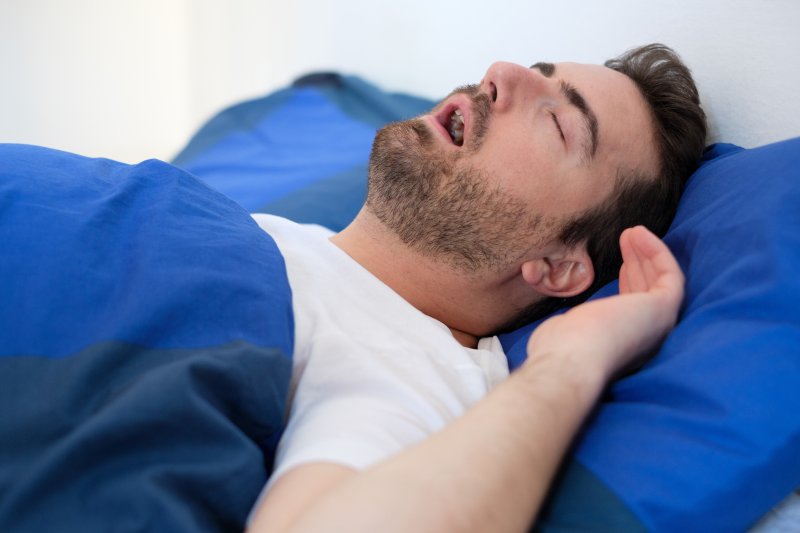 A snoring man suffering from sleep apnea